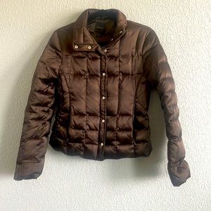 Express brown puffy jacket. Zip up with snap buttons and zip pockets on sides